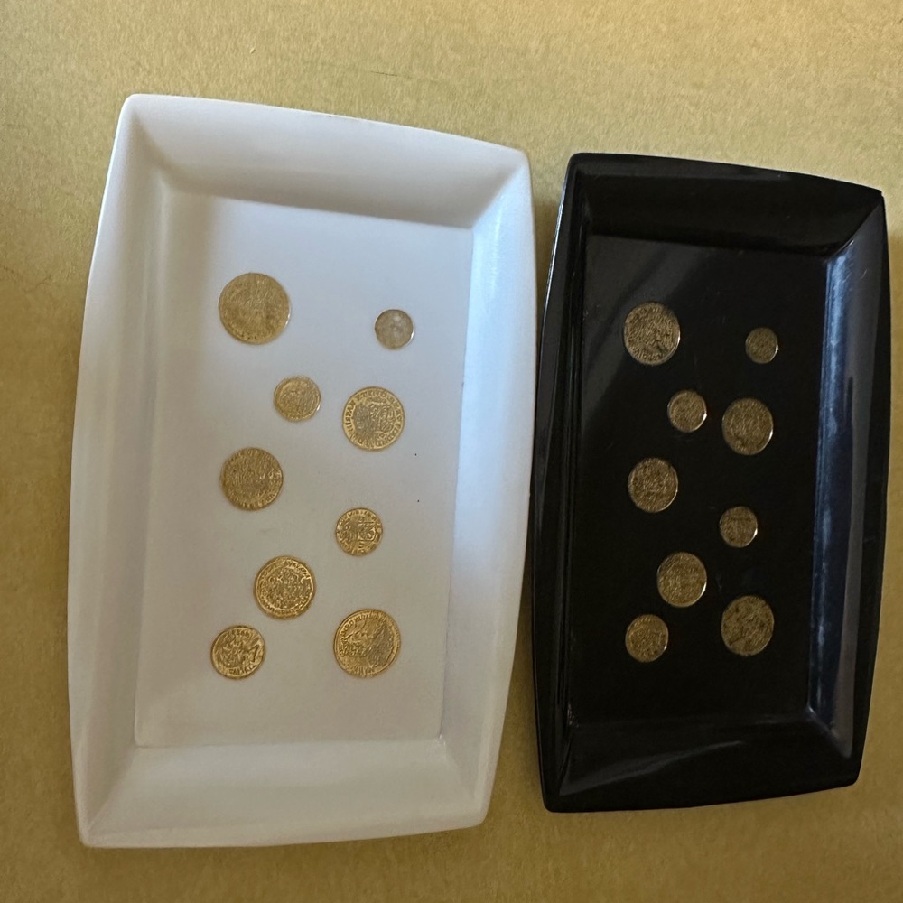 Two celluloid/Bakelite(?) trays, 1 black, 1 cream with gold European coins